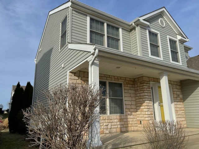 view of side of home featuring stone siding