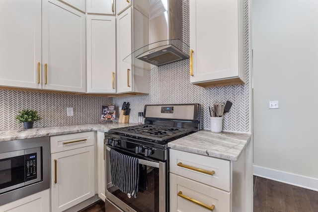 kitchen featuring baseboards, decorative backsplash, wall chimney exhaust hood, dark wood-style flooring, and stainless steel appliances