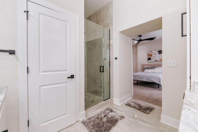 full bath featuring a stall shower, ensuite bath, and baseboards