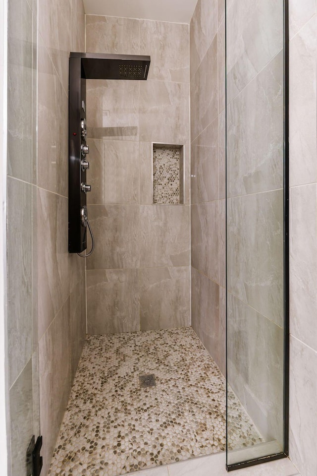 full bath with a tile shower