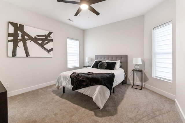 bedroom featuring a ceiling fan, baseboards, visible vents, and carpet flooring