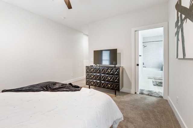 bedroom with light carpet, connected bathroom, and baseboards