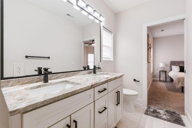 bathroom with visible vents, a sink, toilet, and double vanity