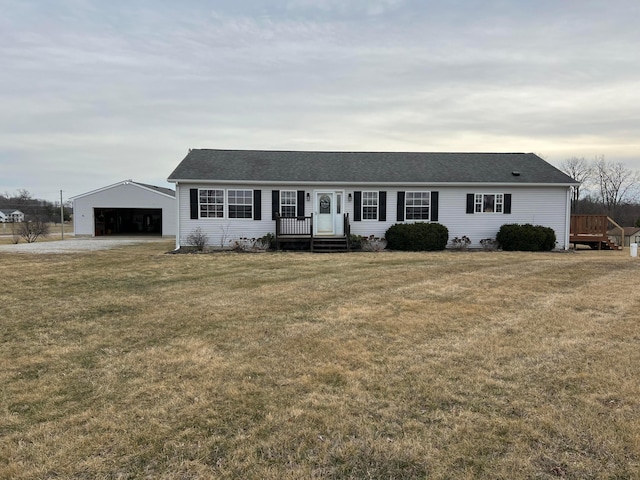 ranch-style home with a front yard, an outdoor structure, and a detached garage