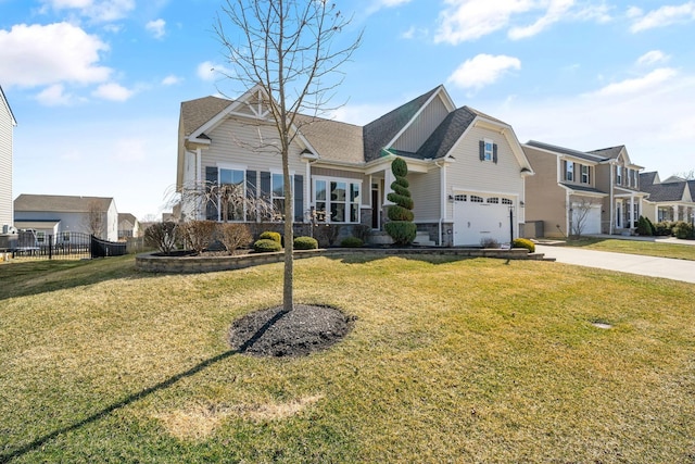 view of front facade featuring stone siding, concrete driveway, a front yard, and fence