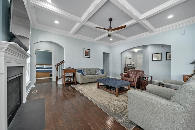 living room with a ceiling fan, arched walkways, coffered ceiling, and dark wood-style flooring