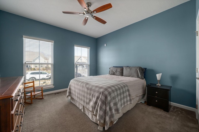 carpeted bedroom featuring visible vents, baseboards, and a ceiling fan