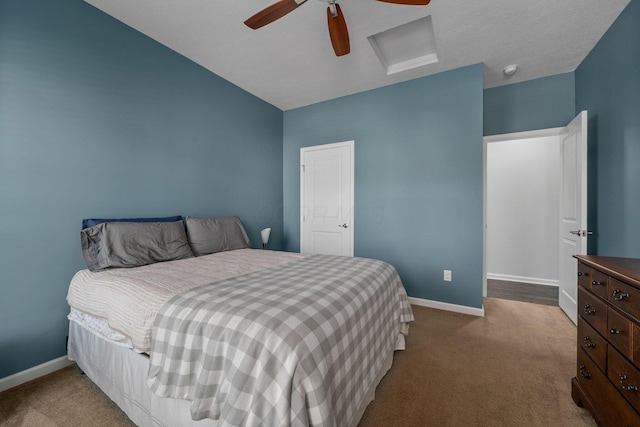 bedroom with attic access, carpet flooring, a ceiling fan, and baseboards