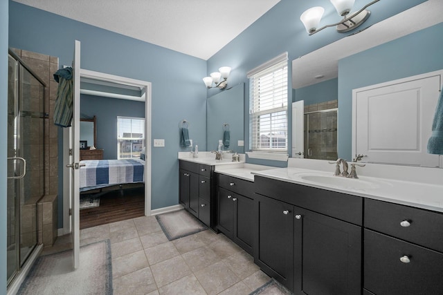 ensuite bathroom with a stall shower, connected bathroom, tile patterned flooring, baseboards, and vanity