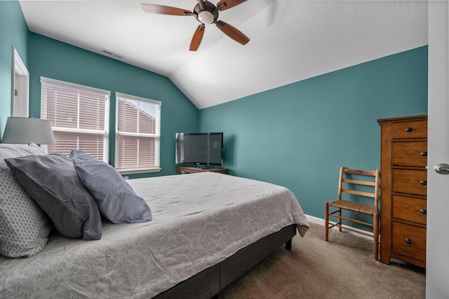 carpeted bedroom with lofted ceiling, a ceiling fan, visible vents, and baseboards