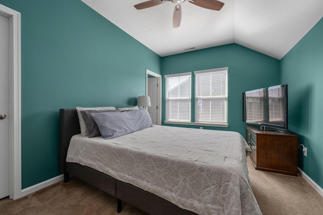 bedroom featuring visible vents, a ceiling fan, carpet flooring, baseboards, and vaulted ceiling