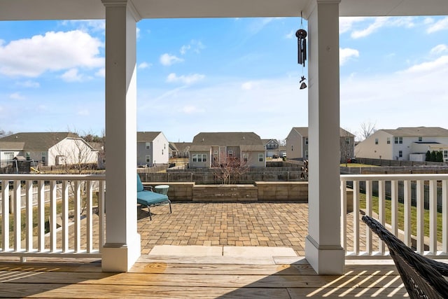 view of patio with a residential view and fence