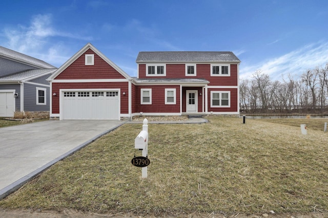 view of front of house featuring a garage, driveway, and a front lawn