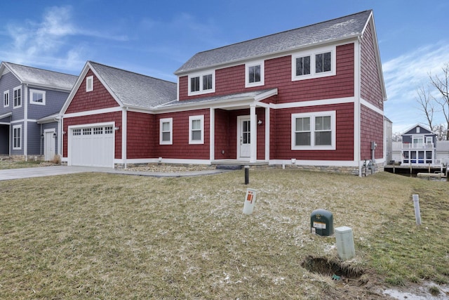 view of front facade featuring an attached garage, a front lawn, concrete driveway, and roof with shingles