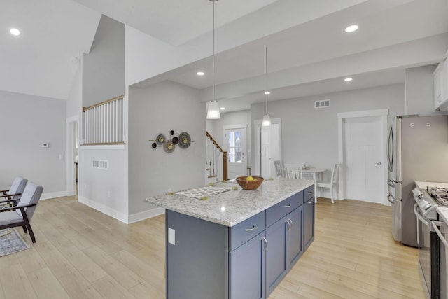 kitchen with recessed lighting, a kitchen island, visible vents, light wood-style floors, and gas range