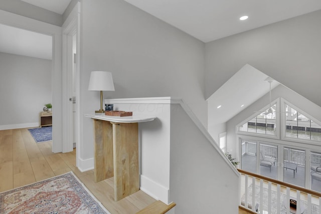 staircase with recessed lighting, wood finished floors, and baseboards