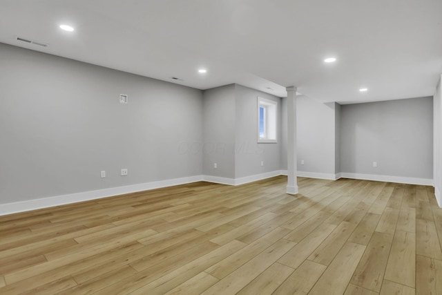 below grade area featuring baseboards, light wood-type flooring, visible vents, and recessed lighting