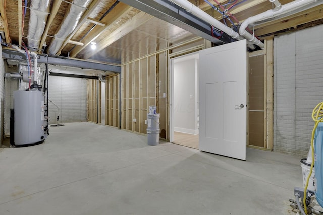 unfinished basement featuring gas water heater