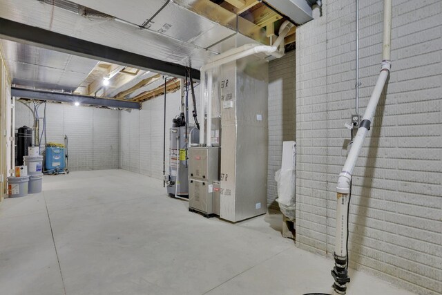 unfinished basement featuring heating unit and gas water heater