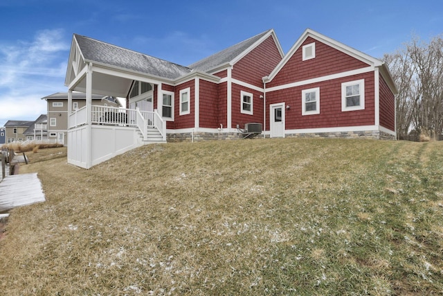 exterior space featuring a lawn and central air condition unit