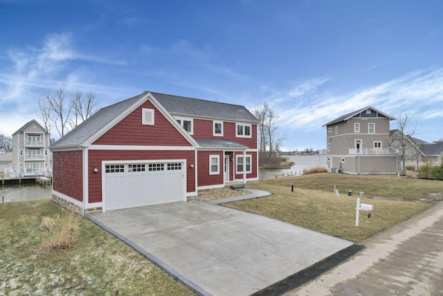 view of front of house featuring driveway, an attached garage, and a front lawn