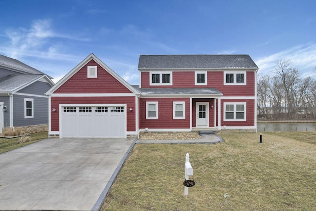 view of front of house with a garage, driveway, and a front lawn