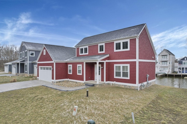 view of front of house featuring a front lawn, concrete driveway, roof with shingles, and an attached garage