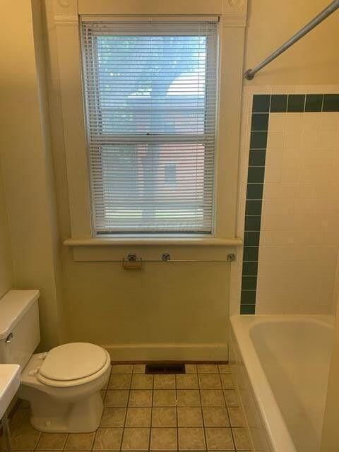 full bathroom featuring toilet, tile patterned flooring, and visible vents