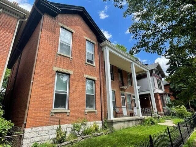 exterior space with fence and brick siding