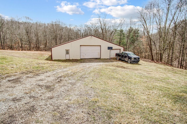 detached garage with a forest view