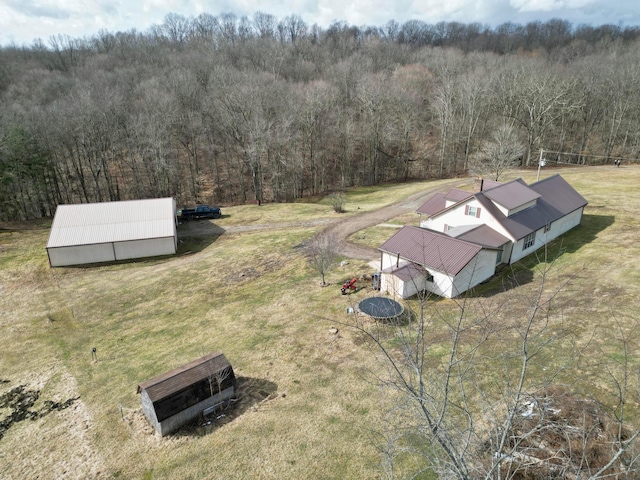 birds eye view of property featuring a view of trees