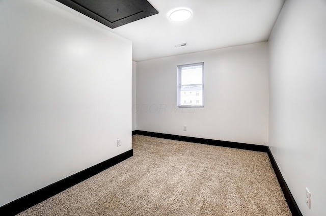 carpeted empty room with baseboards