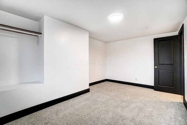 unfurnished bedroom with carpet and baseboards