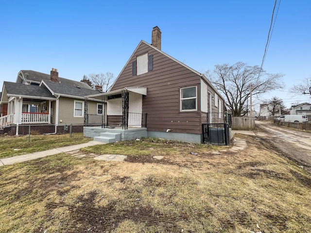 view of front of home with fence and central air condition unit