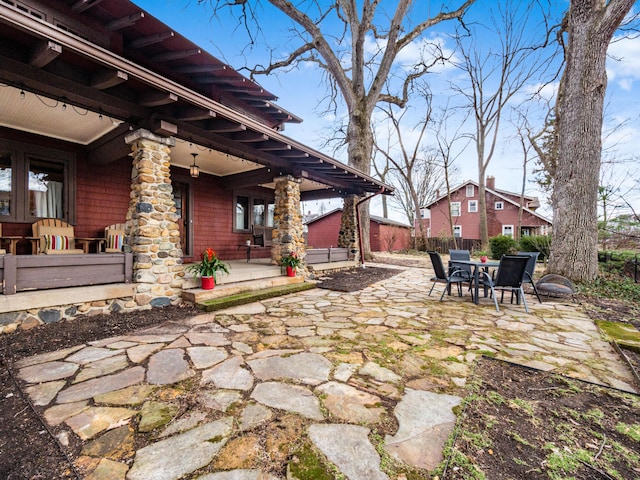 view of patio with outdoor dining space and fence