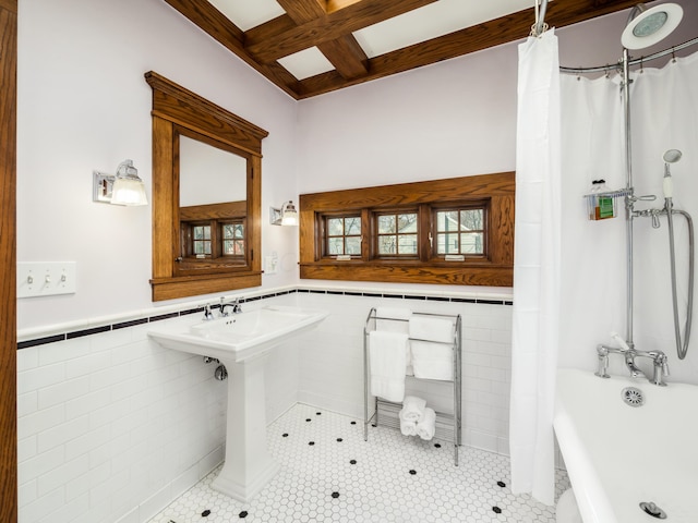 full bathroom with curtained shower, a wainscoted wall, coffered ceiling, tile walls, and a freestanding bath