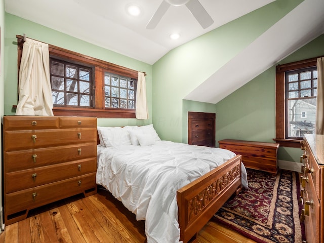 bedroom featuring lofted ceiling, hardwood / wood-style flooring, multiple windows, and recessed lighting