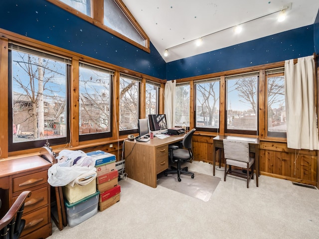 home office with carpet floors, plenty of natural light, high vaulted ceiling, and track lighting