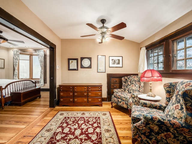 living area with light wood-style flooring and a ceiling fan