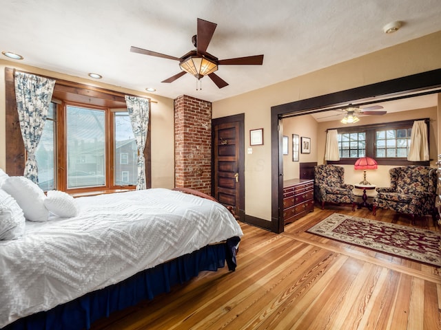 bedroom with ceiling fan, light wood finished floors, recessed lighting, and baseboards