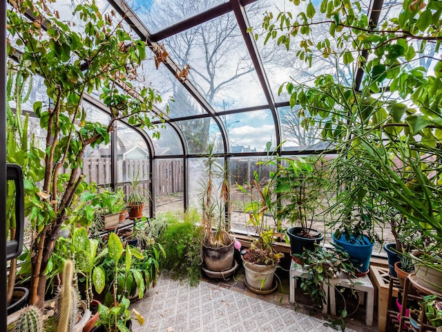 view of patio with a lanai and fence