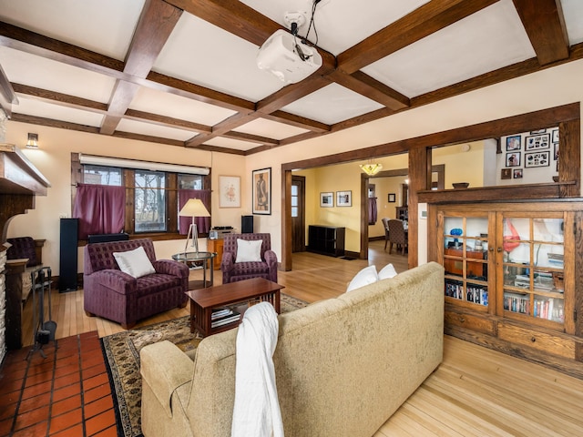 living room with beam ceiling, coffered ceiling, baseboards, and wood finished floors