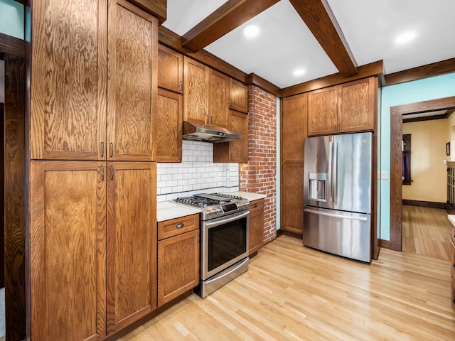 kitchen with beam ceiling, stainless steel appliances, light wood-style flooring, decorative backsplash, and under cabinet range hood