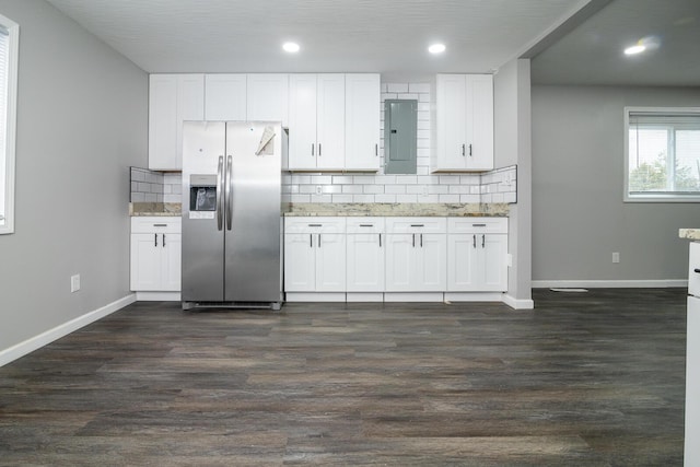 kitchen with tasteful backsplash, white cabinets, dark wood finished floors, and stainless steel refrigerator with ice dispenser