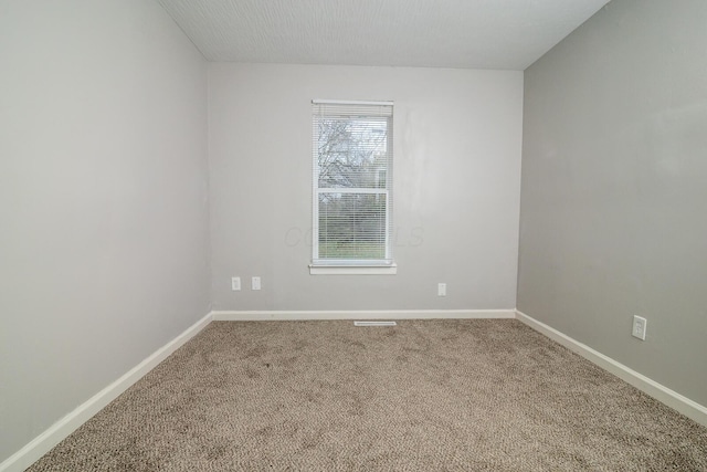 empty room with carpet floors and baseboards