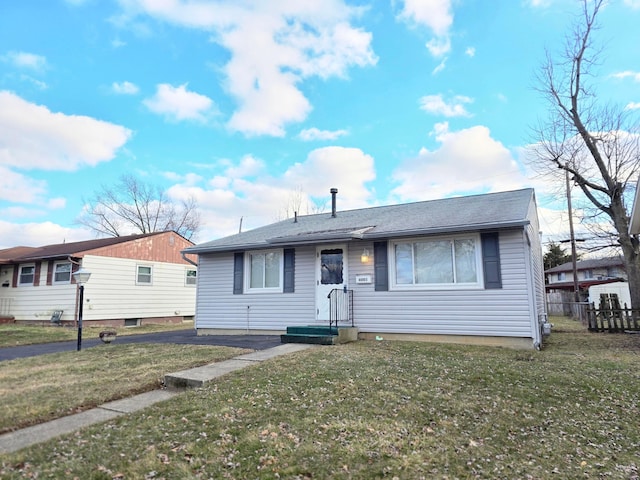 view of front of property with a front yard and fence