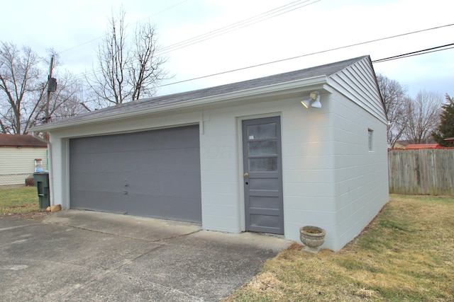 detached garage featuring fence