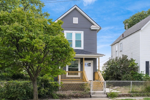 view of front facade featuring covered porch, a fenced front yard, and a gate