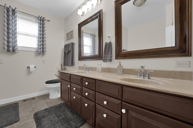bathroom featuring a wealth of natural light, tile patterned flooring, and a sink