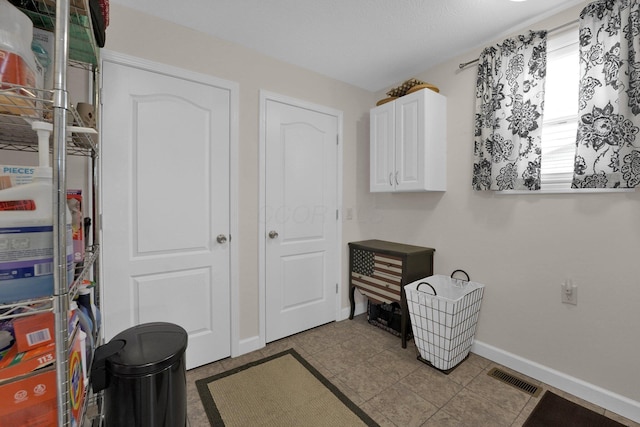 interior space with visible vents and baseboards